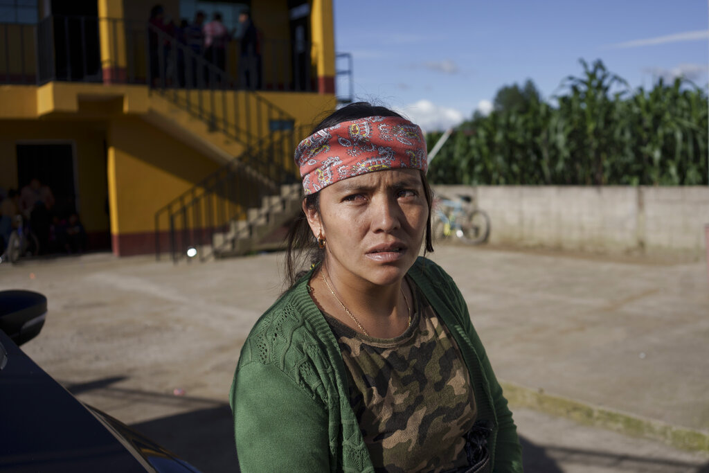 Maria Sipac Coj, mother of Pascual Melvin Guachiac, waits for the start of a community meeting in Tzucubal, Guatemala, Wednesday, June 29, 2022. Pascual and his cousin Wilmer Tulul, both 13, were among the dead discovered inside a tractor-trailer near auto salvage yards on the edge of San Antonio, Texas, on Monday, in what is believed to be the nation's deadliest smuggling episode on the U.S.-Mexico border. (AP Photo/Moises Castillo)