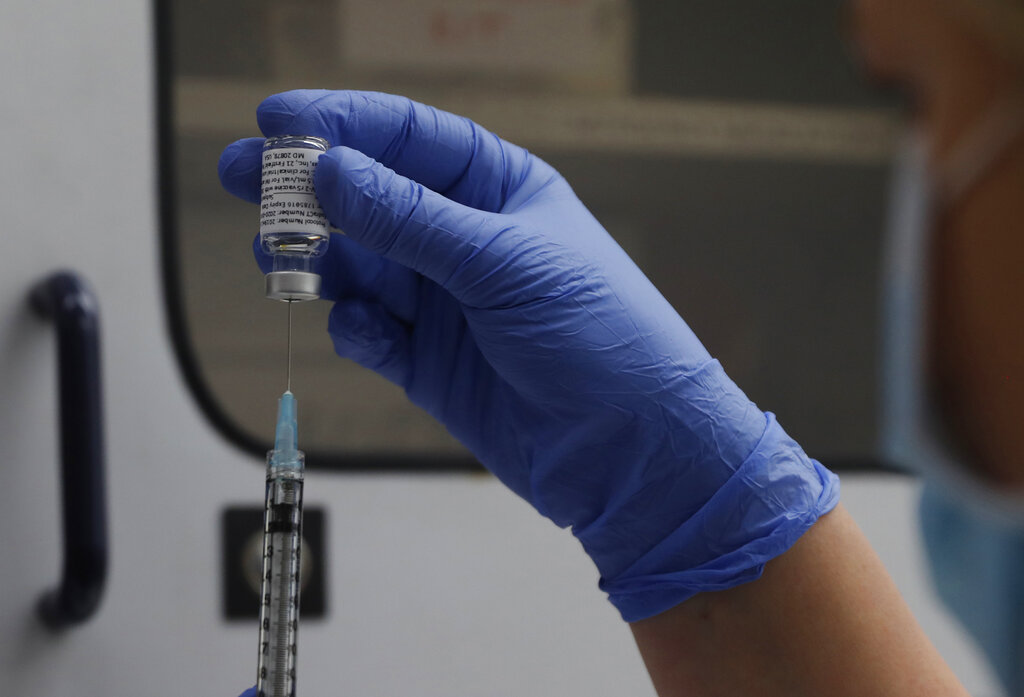 A vial of the Phase 3 Novavax coronavirus vaccine is seen ready for use in the trial at St. George's University hospital in London Wednesday, Oct. 7, 2020. Novavax Inc. said Thursday Jan. 28, 2021 that its COVID-19 vaccine appears 89% effective based on early findings from a British study and that it also seems to work — though not as well — against new mutated strains of the virus circulating in that country and South Africa. (AP Photo/Alastair Grant)