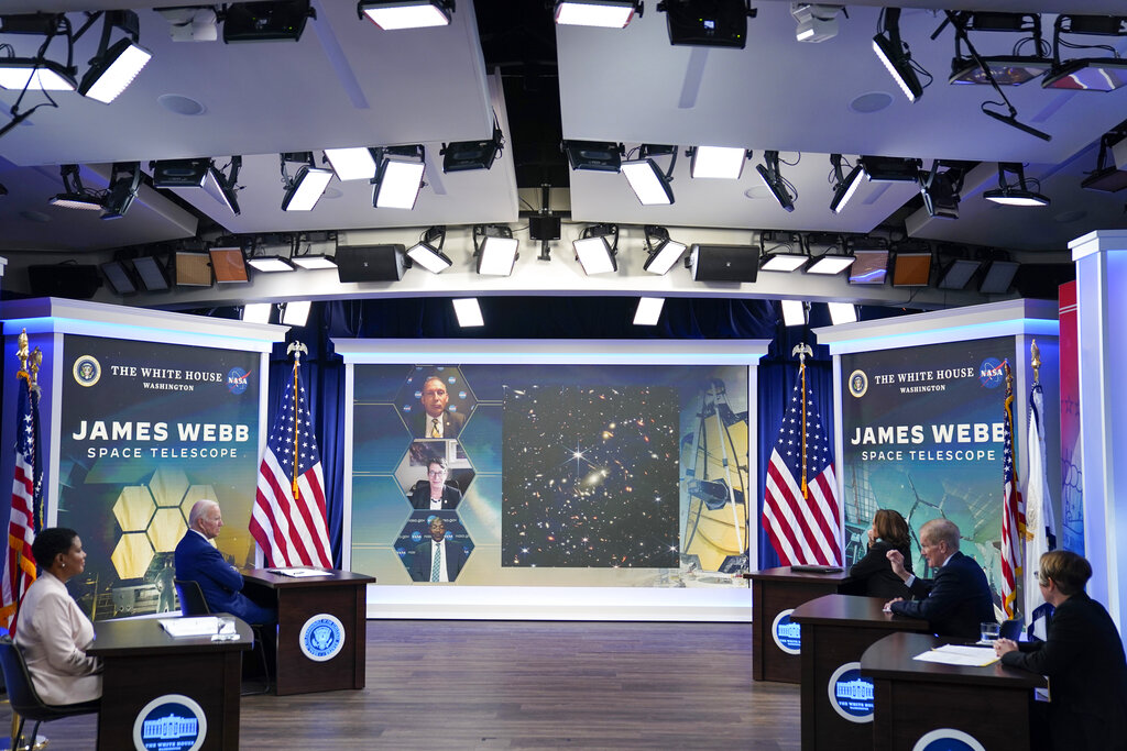 President Joe Biden speaks during a briefing from NASA officials about the first images from the Webb Space Telescope, the highest-resolution images of the infrared universe ever captured, in the South Court Auditorium on the White House complex, Monday, July 11, 2022, in Washington. On screen are NASA Associate Administrator for the Science Mission Directorate Thomas Zurbuchen, top, Deputy Director of the Space Telescope Science Institute (STScI) Nancy Levenson, and NASA James Webb Space Telescope Program Director Greg Robinson, bottom.  (AP Photo/Evan Vucci)