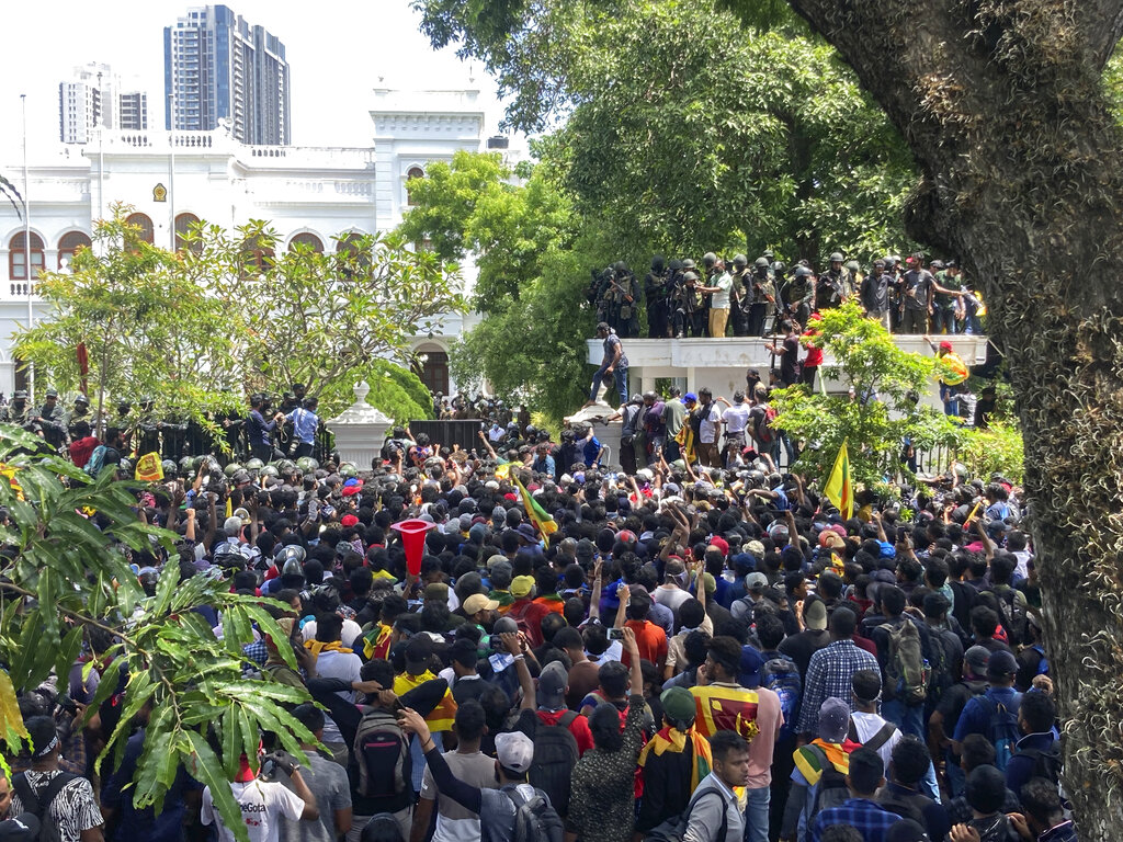 Sri Lankan protesters storm prime minister Ranil Wickremesinghe 's office, demanding he resign after president Gotabaya Rajapaksa fled amid economic crisis in Colombo, Sri Lanka, Wednesday, July 13, 2022. (AP Photo/Rafiq Maqbool)