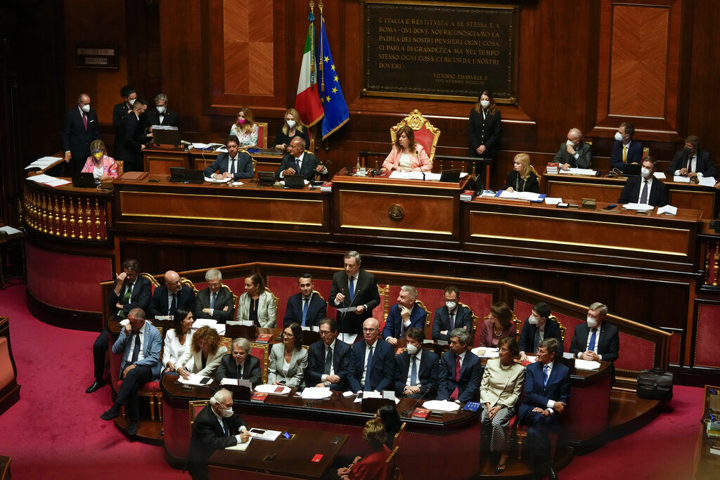 Italian Premier Mario Draghi, bottom center, flanked by Government's Ministers, delivers his speech at the Senate in Rome, Wednesday, July 20, 2022. Draghi was deciding Wednesday whether to confirm his resignation or reconsider appeals to rebuild his parliamentary majority after the populist 5-Star Movement triggered a crisis in the government by withholding its support. (AP Photo/Andrew Medichini)