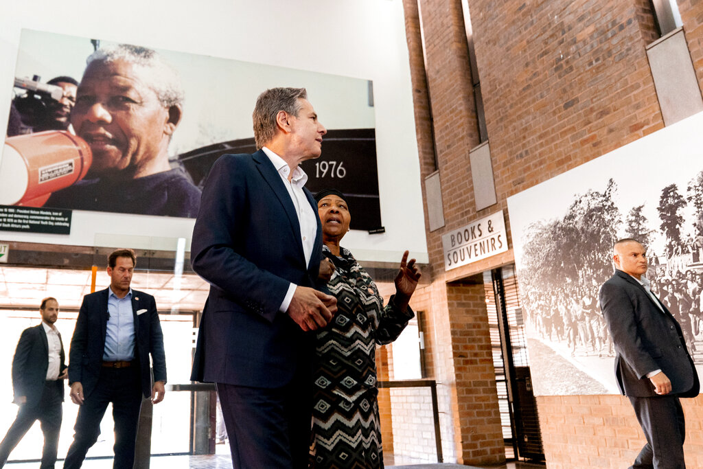 Secretary of State Antony Blinken and Antoinette Sithole, the sister of the late Hector Pieterson, tour the Hector Pieterson Memorial in Soweto, South Africa, Sunday, Aug. 7, 2022. Peaceful child protesters were gunned down by police 30 years ago in an attack that awakened the world to the brutality of the apartheid regime. At top, is an iconic picture of Antoinette, running with mouth open in a scream alongside a friend carrying the body of her slain brother, Hector. (AP Photo/Andrew Harnik, Pool)