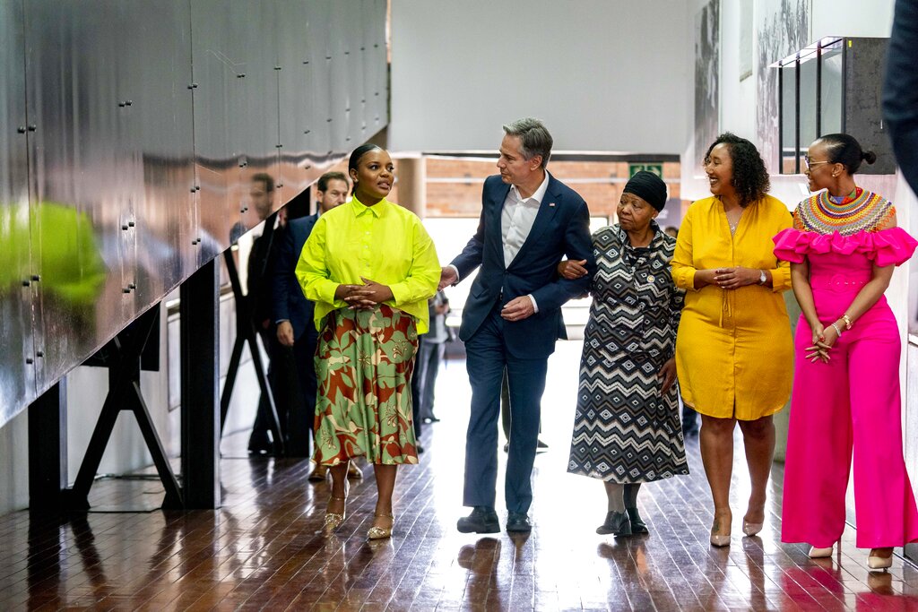 Secretary of State Antony Blinken, center, Antoinette Sithole, the sister of the late Hector Pieterson, third from right, and Young African Leaders Initiative Mandela Washington Fellows, Nazley Sharif, second from right, Thembiso Magajana, left, and Simphiwe Mamvura, right, tour the Hector Pieterson Memorial in Soweto, South Africa, Sunday, Aug. 7, 2022. Peaceful child protesters were gunned down by police 30 years ago in an attack that awakened the world to the brutality of the apartheid regime. (AP Photo/Andrew Harnik, Pool)