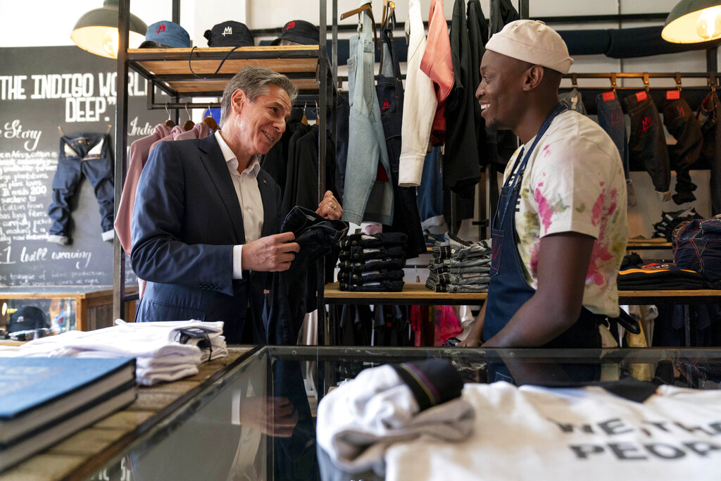 Secretary of State Antony Blinken shares a joke with jeans designer Tshepo he tours the Victoria Yards neighborhood in Johannesburg, South Africa, Sunday, Aug. 7, 2022. Blinken is on a ten day trip to Cambodia, Philippines, South Africa, Congo, and Rwanda. (AP Photo/Andrew Harnik, Pool)