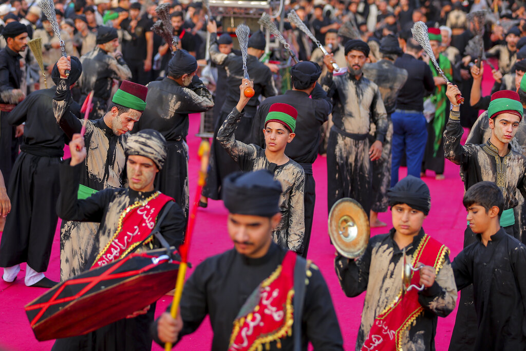 Iraqi Shiites take part in Ashura that marks the martyrdom of Husayn ibn Ali, a grandson of the Islamic prophet Muhammad, and members of his immediate family in the Battle of Karbala, in Karbala, Iraq, Monday, Aug. 8, 2022. (AP Photo/Anmar Khalil)
