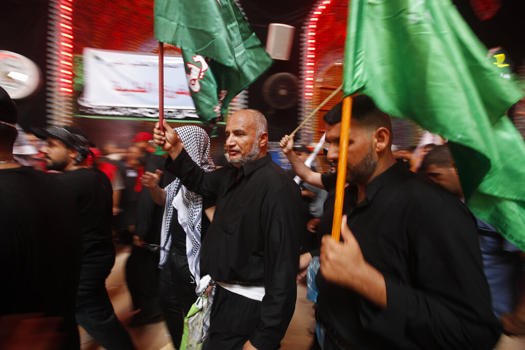 Iraqi Shiites attend the Ashore ceremonies in Karbala, Iraq, Tuesday, Aug. 9, 2022. Ashoura marks the death of Husayn ibn Ali, a grandson of the Islamic prophet Muhammad, and members of his immediate family in the Battle of Karbala. (AP Photo/Anmar Khalil)