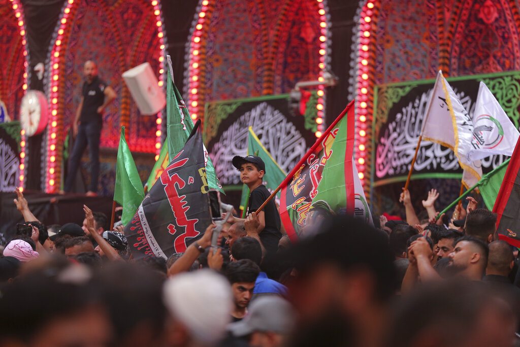 Iraqi Shiites attend the Ashore ceremonies in Karbala, Iraq, Tuesday, Aug. 9, 2022. Ashoura marks the death of Husayn ibn Ali, a grandson of the Islamic prophet Muhammad, and members of his immediate family in the Battle of Karbala. (AP Photo/Anmar Khalil)