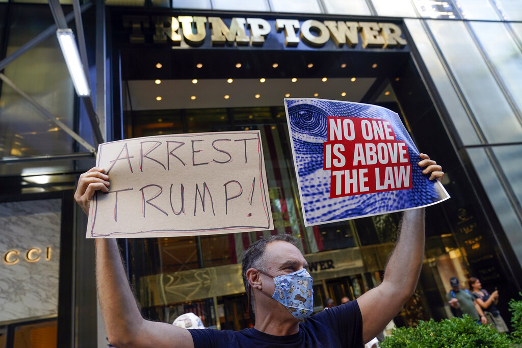 A protester stands in front of Trump Tower in New York, Tuesday, Aug. 9, 2022. The FBI's search of Donald Trump's Mar-a-Lago estate marked a dramatic and unprecedented escalation of the law enforcement scrutiny of the former president, but the Florida operation was just one part of one investigation related to Trump and his time in office. (AP Photo/Seth Wenig)