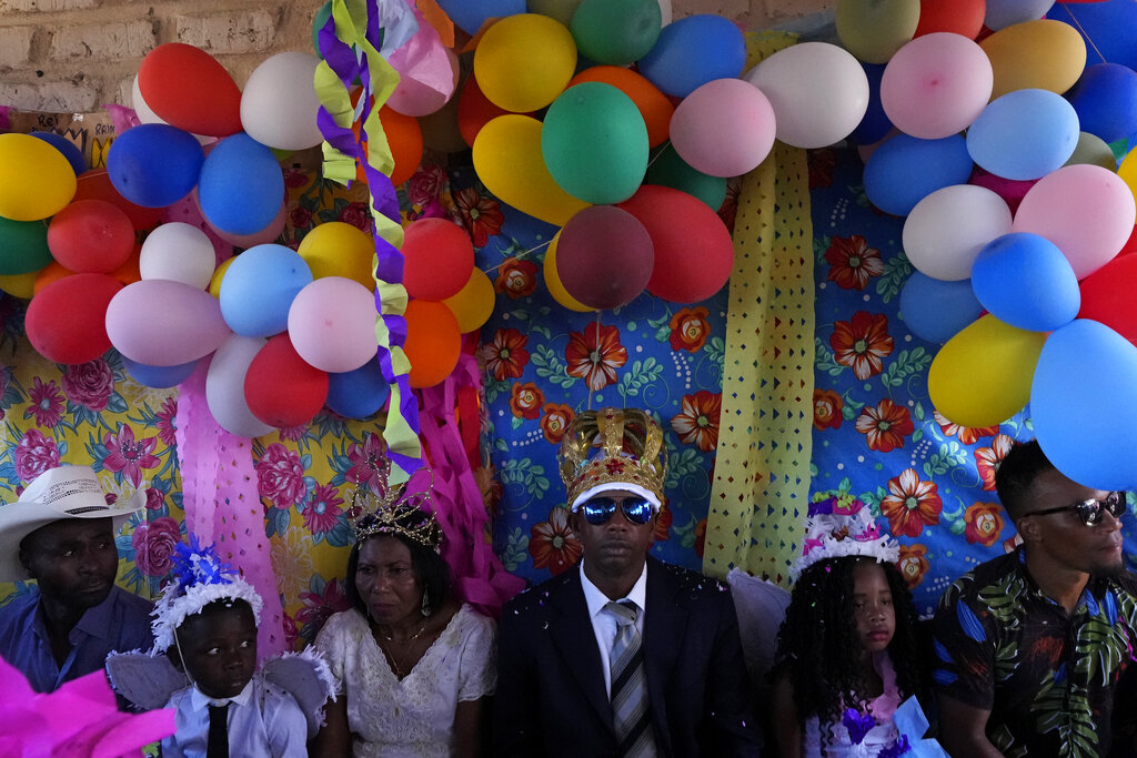 Adonildes da Cunha, right, Emperor, and Nilda dos Santos, left, Queen, arrive for a celebration after Mass in the chapel of the Kalunga quilombo, during the culmination of the week-long pilgrimage and celebration for the patron saint 