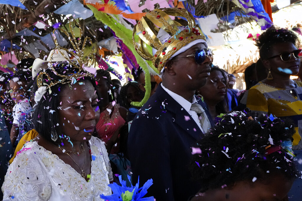 Adonildes da Cunha, right, Emperor, and Nilda dos Santos, left, Queen, arrive for a celebration after a Mass in the chapel of the Kalunga quilombo, during the culmination of the week-long pilgrimage and celebration for the patron saint 