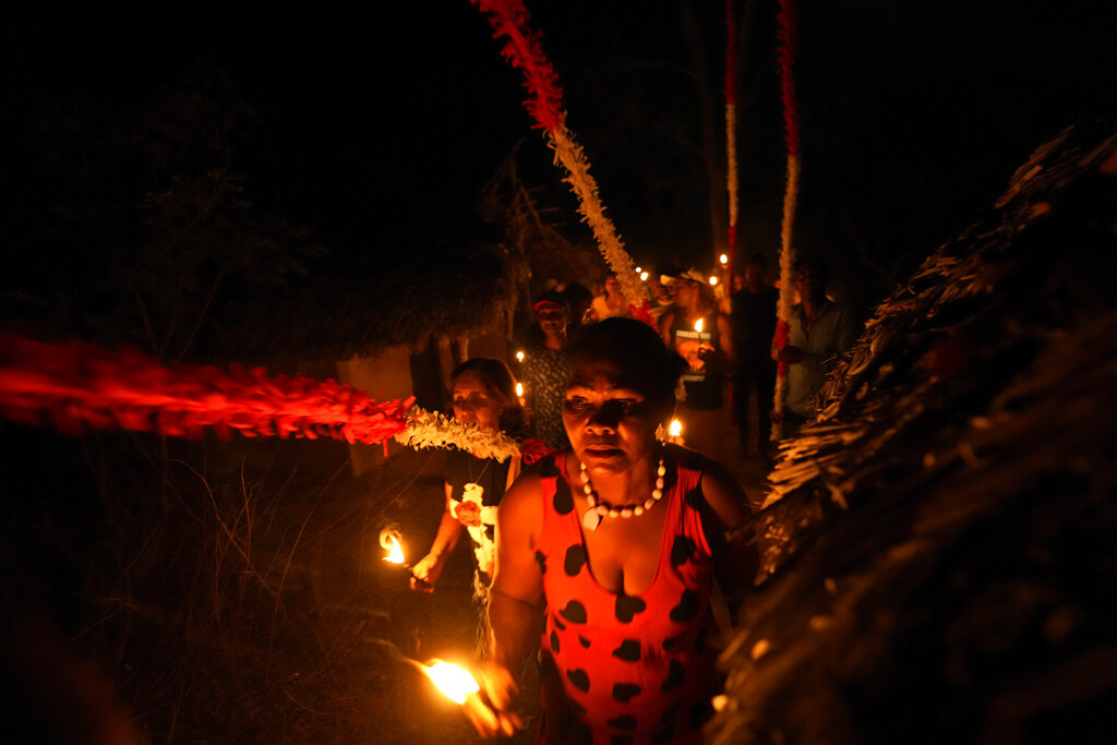 A member of the Kalunga quilombo, the descendants of runaway slaves, take part in the candlelight procession during the culmination of the week-long pilgrimage and celebration for the patron saint 
