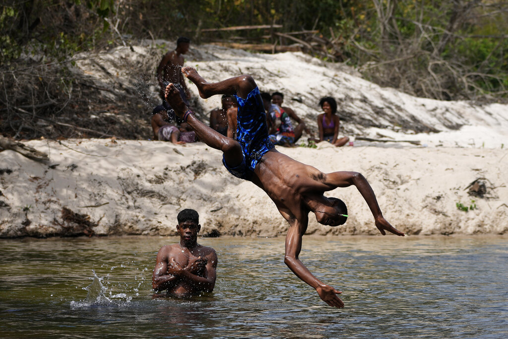 Members of the Kalunga quilombo, the descendants of runaway slaves, bathe in Rio Branco, during the culmination of the week-long pilgrimage and celebration for the patron saint 