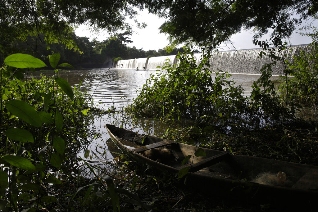 A fishing canoe sits near a dam that sources the sacred Osun River in Esa-Odo, Nigeria, on Saturday, May 28, 2022. The river, which flows through the dense forest of the Osun-Osogbo Sacred Grove — designated a UNESCO World Heritage Site in 2005 — is revered for its cultural and religious significance among the Yoruba-speaking people predominant in southwestern Nigeria, where the goddess Osun is widely worshipped. (AP Photo/Sunday Alamba)