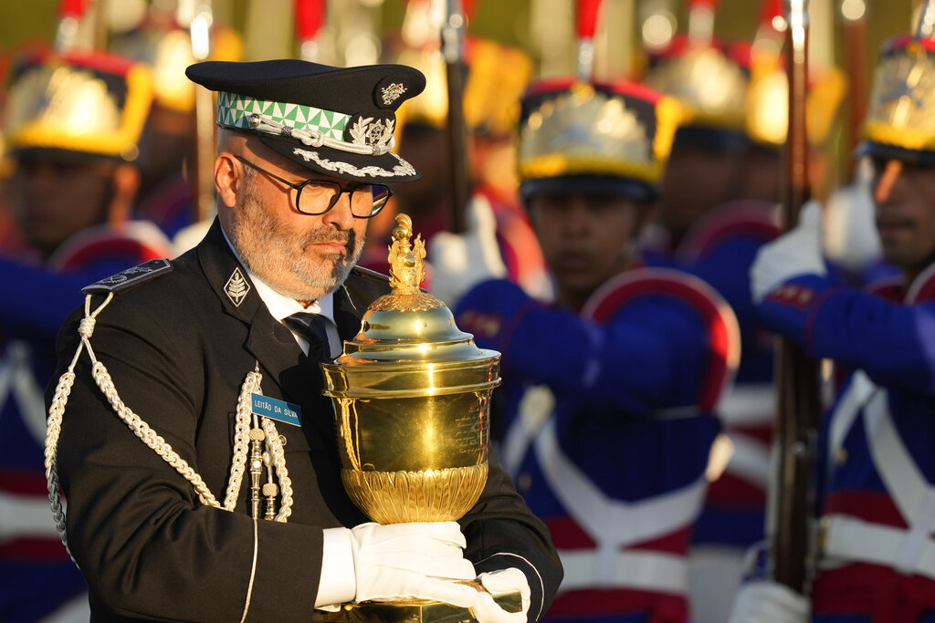 A Portuguese military officer carries a reliquary with the heart of Brazil's former emperor Dom Pedro I, during a military ceremony to be received by Brazil's President Jair Bolsonaro, at the Planalto Presidential Palace in Brasilia, Brazil, Tuesday, Aug. 23, 2022. The heart arrived for display during the celebrations of Brazil's independence bicentennial on Sept. 7. (AP Photo/Eraldo Peres)