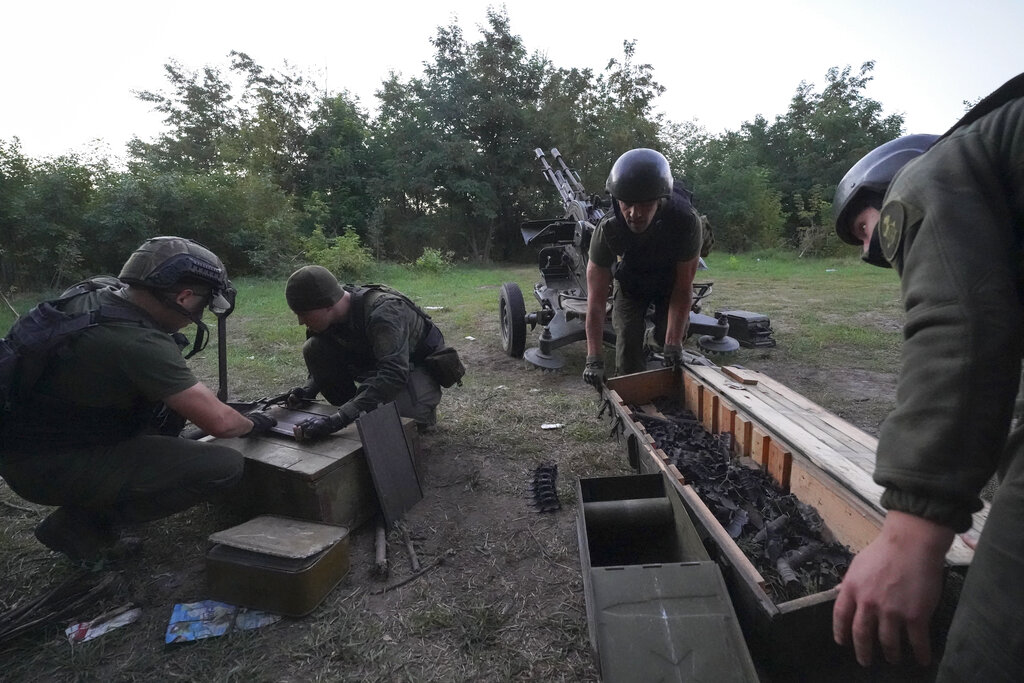 Ukrainian servicemen prepare their weapon to fire Russian positions in Kharkiv region, Ukraine, early Wednesday, Aug. 24, 2022. (AP Photo/Andrii Marienko)