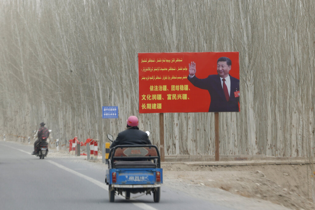 FILE - Chinese President Xi Jinping is seen on a billboard with the slogan, 