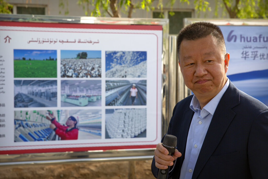 Li Qiang, general manager of Huafu Fashion, speaks outside the company's plant during a government organized trip for foreign journalists in Aksu in western China's Xinjiang Uyghur Autonomous Region, Tuesday, April 20, 2021. A backlash against reports of forced labor and other abuses of the largely Muslim Uyghur ethnic group in Xinjiang is taking a toll on China's cotton industry, but it's unclear if the pressure will compel the government or companies to change their ways. (AP Photo/Mark Schiefelbein)