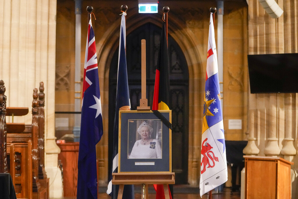 A portrait of Queen Elizabeth II is displayed at St. Andrews Cathedral in Sydney, Australia, Friday, Sept. 9, 2022. Queen Elizabeth II, Britain's longest-reigning monarch and a rock of stability in a turbulent era for her country and the world, died Thursday, Sept. 8 after 70 years on the throne. She was 96. ((AP Photo/Mark Baker)
