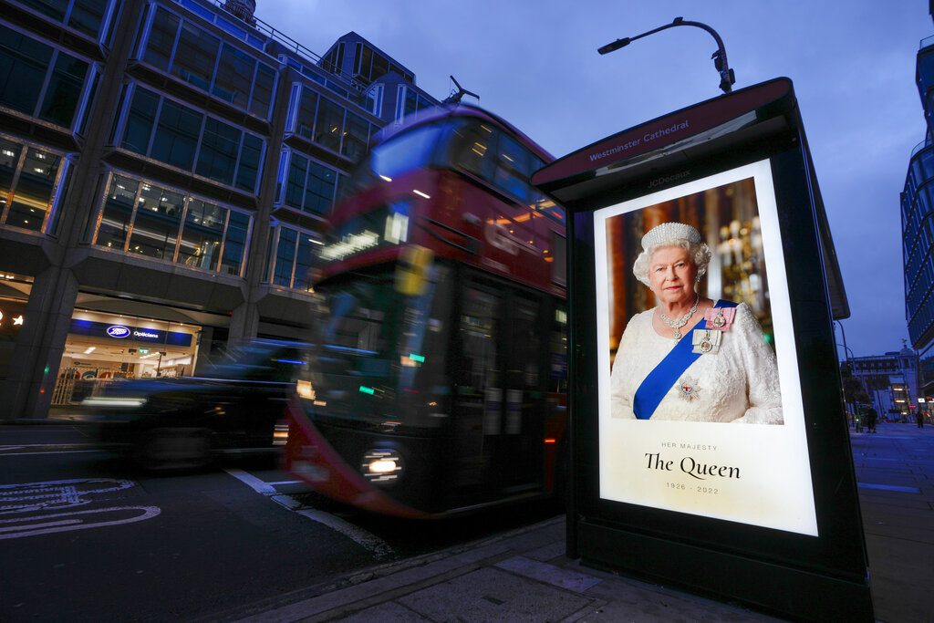 A picture of Queen Elizabeth sits on a bus stop in London, Friday, Sept. 9, 2022. Queen Elizabeth II, Britain's longest-reigning monarch and a rock of stability across much of a turbulent century, died Thursday Sept. 8, 2022, after 70 years on the throne. She was 96. (AP Photo/Kirsty Wigglesworth)
