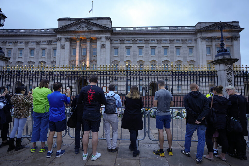 People gather outside Buckingham Palace in London, Friday, Sept. 9, 2022. Queen Elizabeth II, Britain's longest-reigning monarch and a rock of stability across much of a turbulent century, died Thursday Sept. 8, 2022, after 70 years on the throne. She was 96. (AP Photo/Kirsty Wigglesworth)