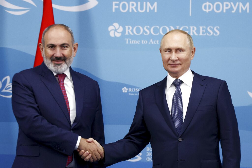 Russian President Vladimir Putin, right, and Armenian Prime Minister Nikol Pashinyan pose for a photo during their meeting on the sideline of the Eastern Economic Forum in Vladivostok, Russia, Wednesday, Sept. 7, 2022. (Valery Sharifulin/TASS News Agency Host Pool Photo via AP)