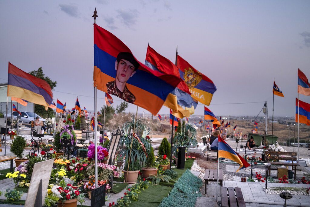 Armenian national flags wave on the wind at the military cemetery with the graves of the fallen soldiers during the during the fighting over Nagorno-Karabakh in 2020 year, outside Yerevan, Armenia. June 16. 2021. Nagorno-Karabakh lies within Azerbaijan but was under the control of ethnic Armenian forces backed by the government in Yerevan since a separatist war ended in 1994, leaving the region and substantial surrounding territory in Armenian hands. Hostilities flared in late September 2020, and the Azerbaijani military pushed deep into Nagorno-Karabakh and nearby areas in six weeks of fighting involving heavy artillery and drones that killed more than 6,000 people. (AP Photo/Areg Balayan)