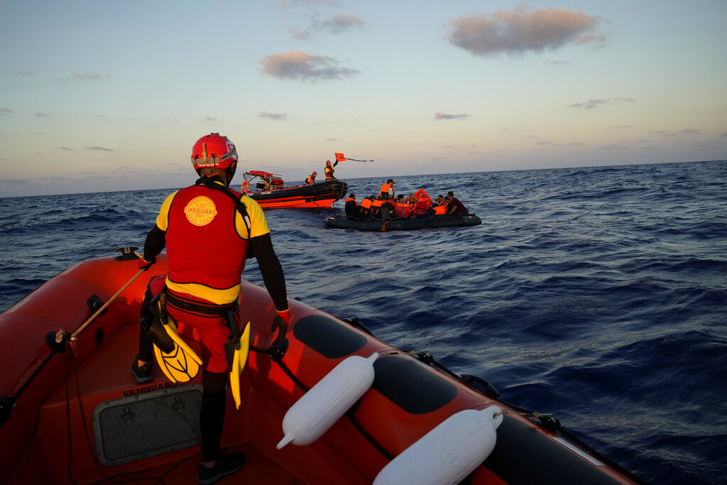 Spanish NGO Open Arms lifeguards approach a rubber boat with migrants during a rescue operation at international waters zone of Libya SAR (Search and Rescue) in the Mediterranean sea, Thursday, Sept. 15, 2022. Seventeen migrants from Syria and Sudan, including six children, were rescued by the NGO Open Arms crew members after their boat overturned and started to sink. (AP Photo/Petros Karadjias)
