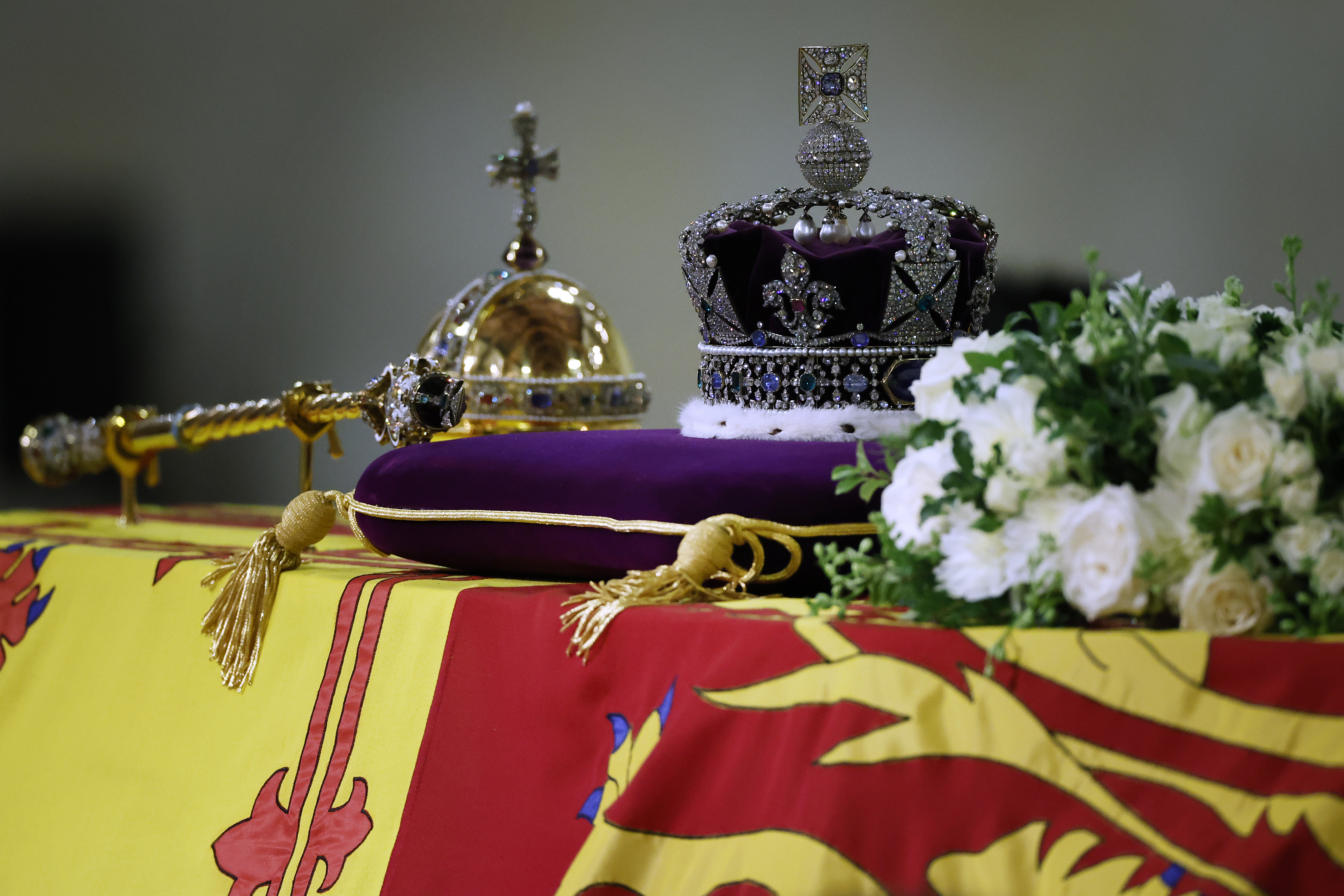 The coffin of Queen Elizabeth II, draped in the Royal Standard with the Imperial State Crown and the Sovereign's orb and sceptre as it lies in state on the catafalque in Westminster Hall, at the Palace of Westminster, London, early Saturday Sept. 17, 2022. The Queen will lie in state in Westminster Hall for four full days before her funeral on Monday Sept. 19. (Chip Somodevilla/Pool via AP)