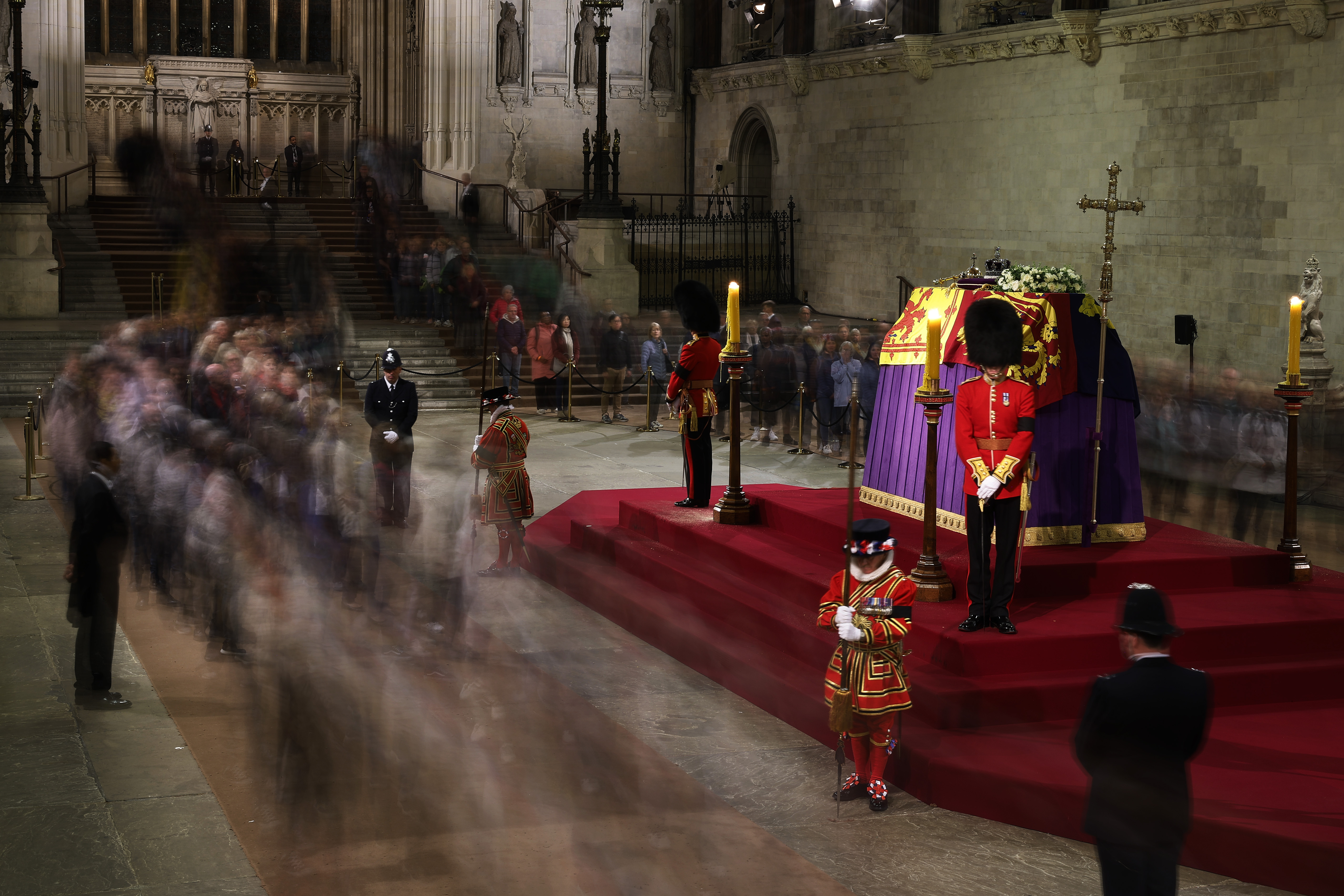 People file past the coffin of Queen Elizabeth II as it lies in state on the catafalque in Westminster Hall, at the Palace of Westminster, London, early Saturday Sept. 17, 2022. The Queen will lie in state in Westminster Hall for four full days before her funeral on Monday Sept. 19. (Chip Somodevilla/Pool via AP)