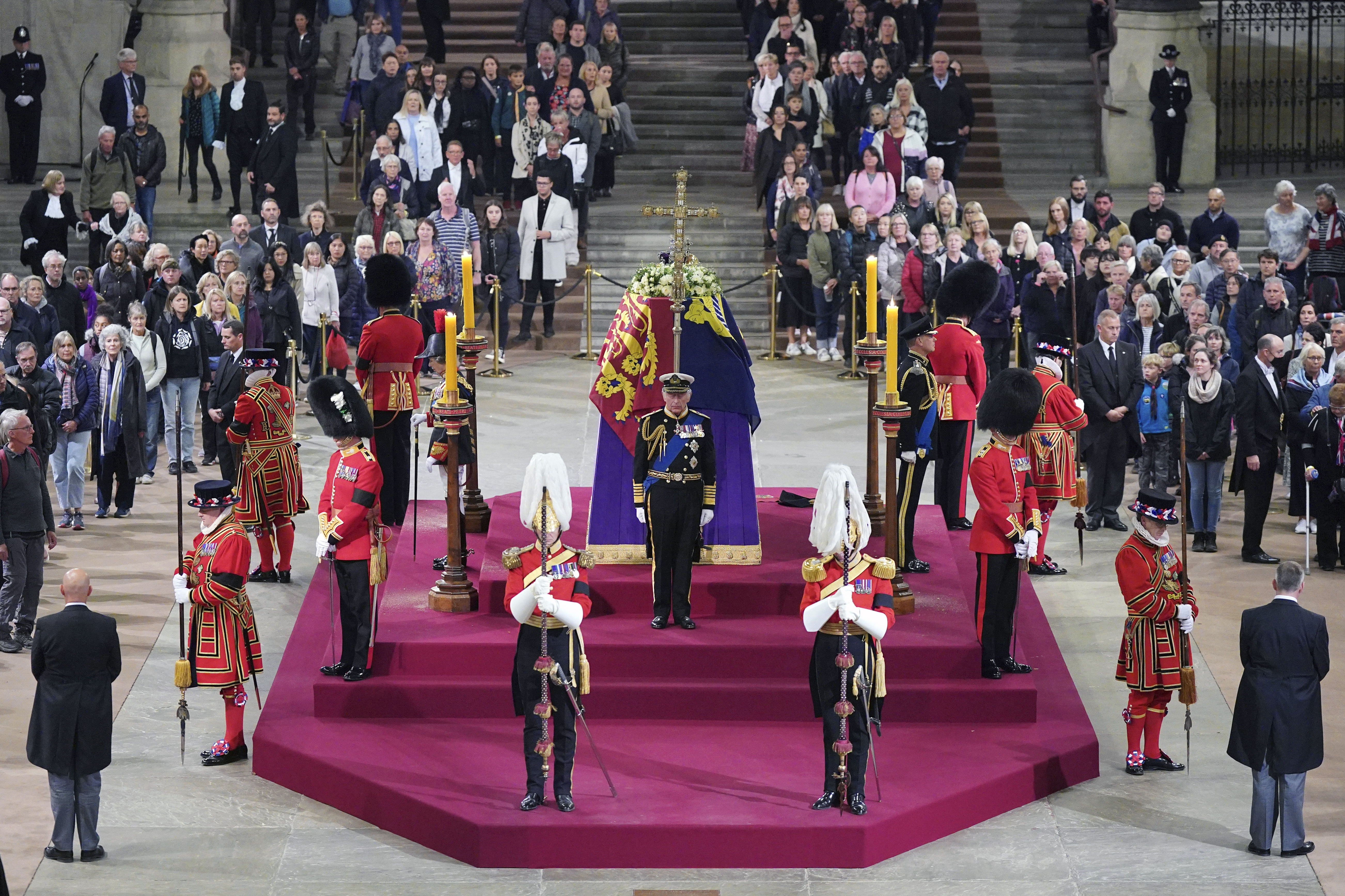 Members of the public file past as King Charles III, the Princess Royal, the Duke of York and the Earl of Wessex hold a vigil beside the coffin of their mother, Queen Elizabeth II, as it lies in state on the catafalque in Westminster Hall, at the Palace of Westminster, London, Friday Sept. 16, 2022. (Yui Mok/Pool Photo via AP)