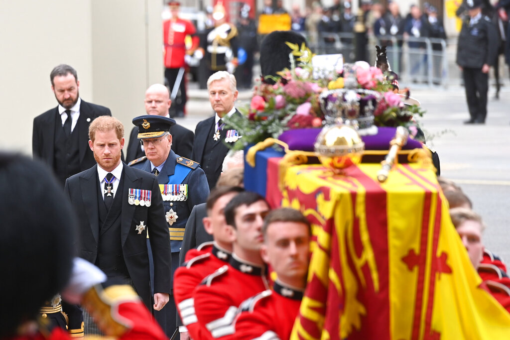 Prince Harry, second left, walks behind the coffin of Queen Elizabeth II ahead of the funeral service at Westminster Abbey in central London, Monday Sept. 19, 2022. The Queen, who died aged 96 on Sept. 8, will be buried at Windsor alongside her late husband, Prince Philip, who died last year. (Geoff Pugh/Pool via AP)