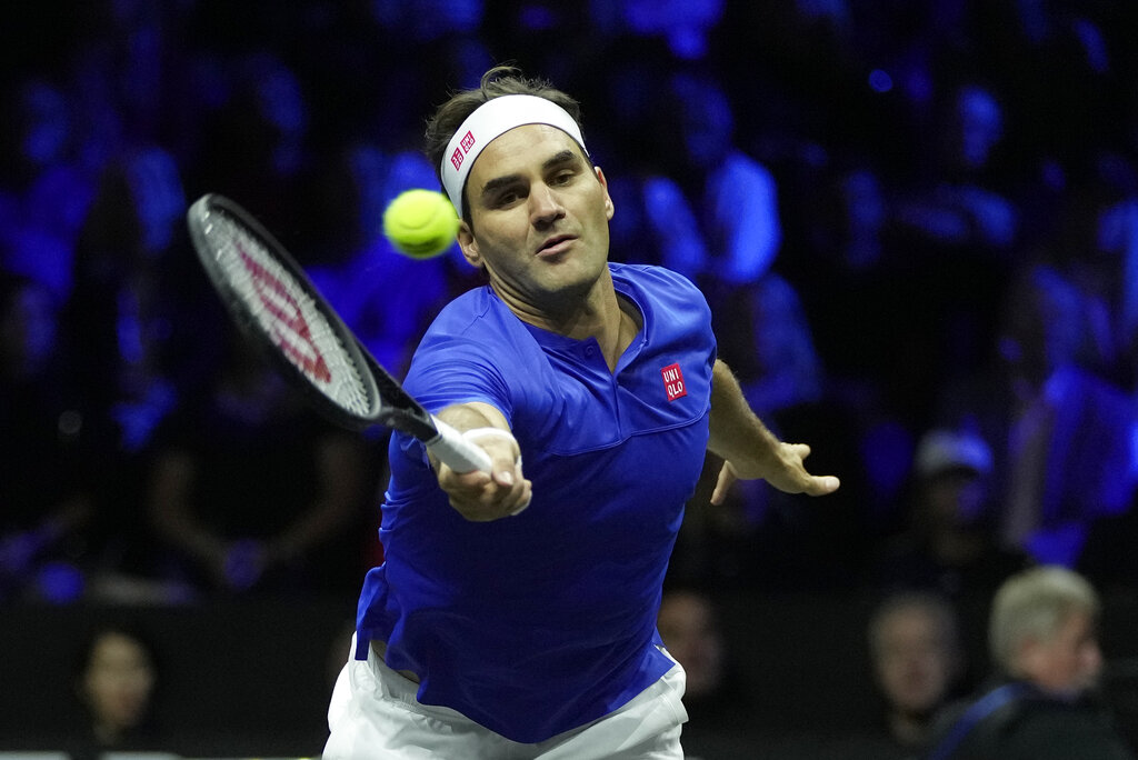 Team Europe's Roger Federer returns the ball as he and Rafael Nadal play in a Laver Cup doubles match against Team World's Jack Sock and Frances Tiafoe at the O2 arena in London, Friday, Sept. 23, 2022. (AP Photo/Kin Cheung)