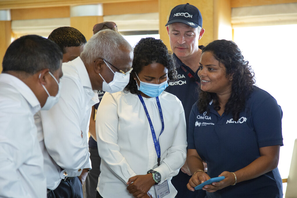 IMAGE DISTRIBUTED FOR NEKTON - From left, Maldives President Ibrahim Mohamed Solih and Environment Minister Shauna Aminath are shown videos of Aquanaut Shaha Hashim's submersible dive during a surprise visit to the Nekton Maldives Mission on Monday, Sept. 12, 2022, in Laamu, Maldives. The President offered support to Nekton scientists in their quest to find answers that can help unlock the secrets of the deep. HANDOUT IMAGE - Please see special instructions. MANDATORY CREDIT - 