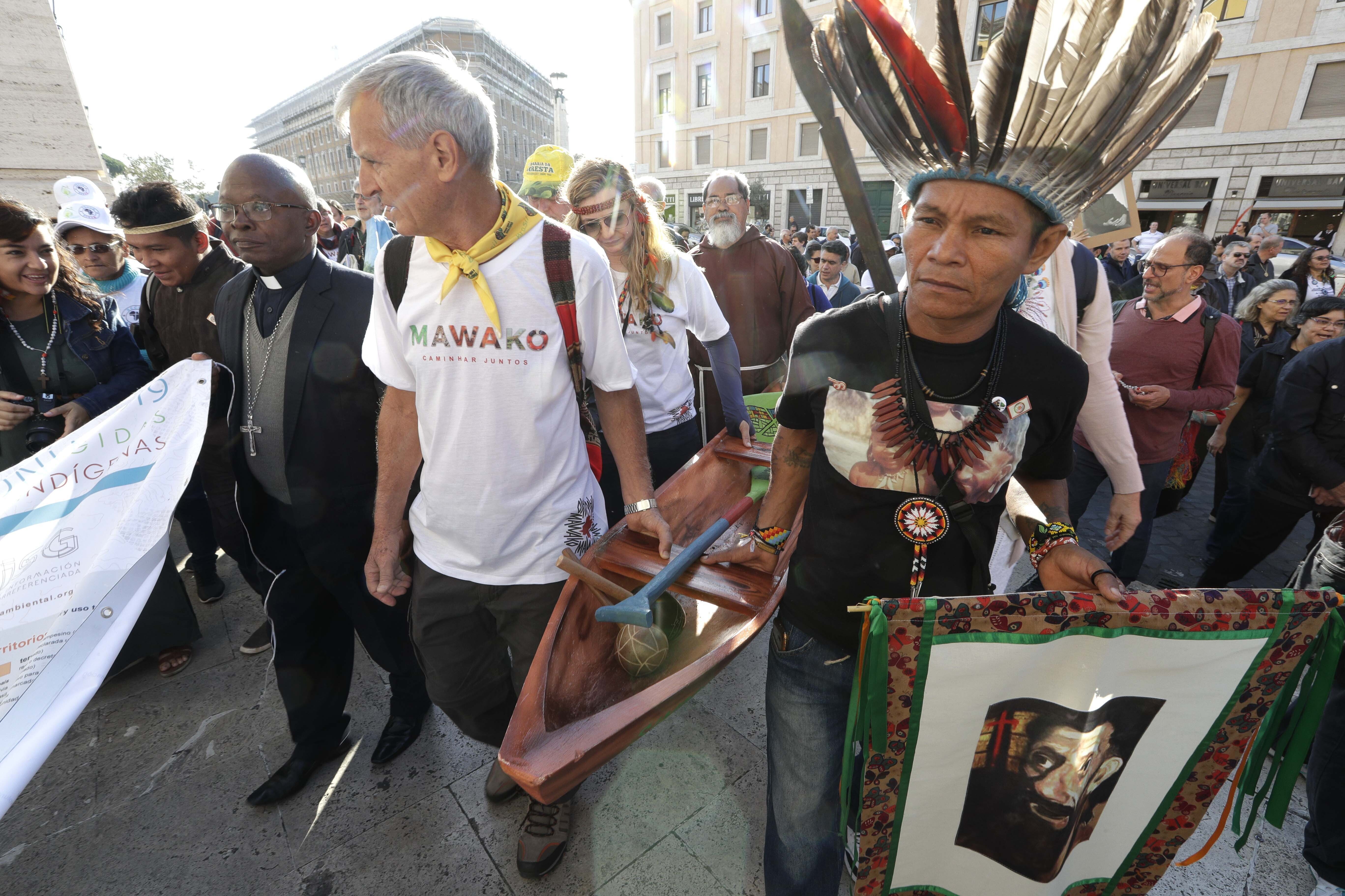 Members of Amazon indigenous populations walk during a Via Crucis (Way of the Cross) procession from St. Angelo Castle to the Vatican, Saturday, Oct. 19, 2019. Pope Francis is holding a three-week meeting on preserving the rainforest and ministering to its native people as he fended off attacks from conservatives who are opposed to his ecological agenda. (AP Photo/Andrew Medichini)