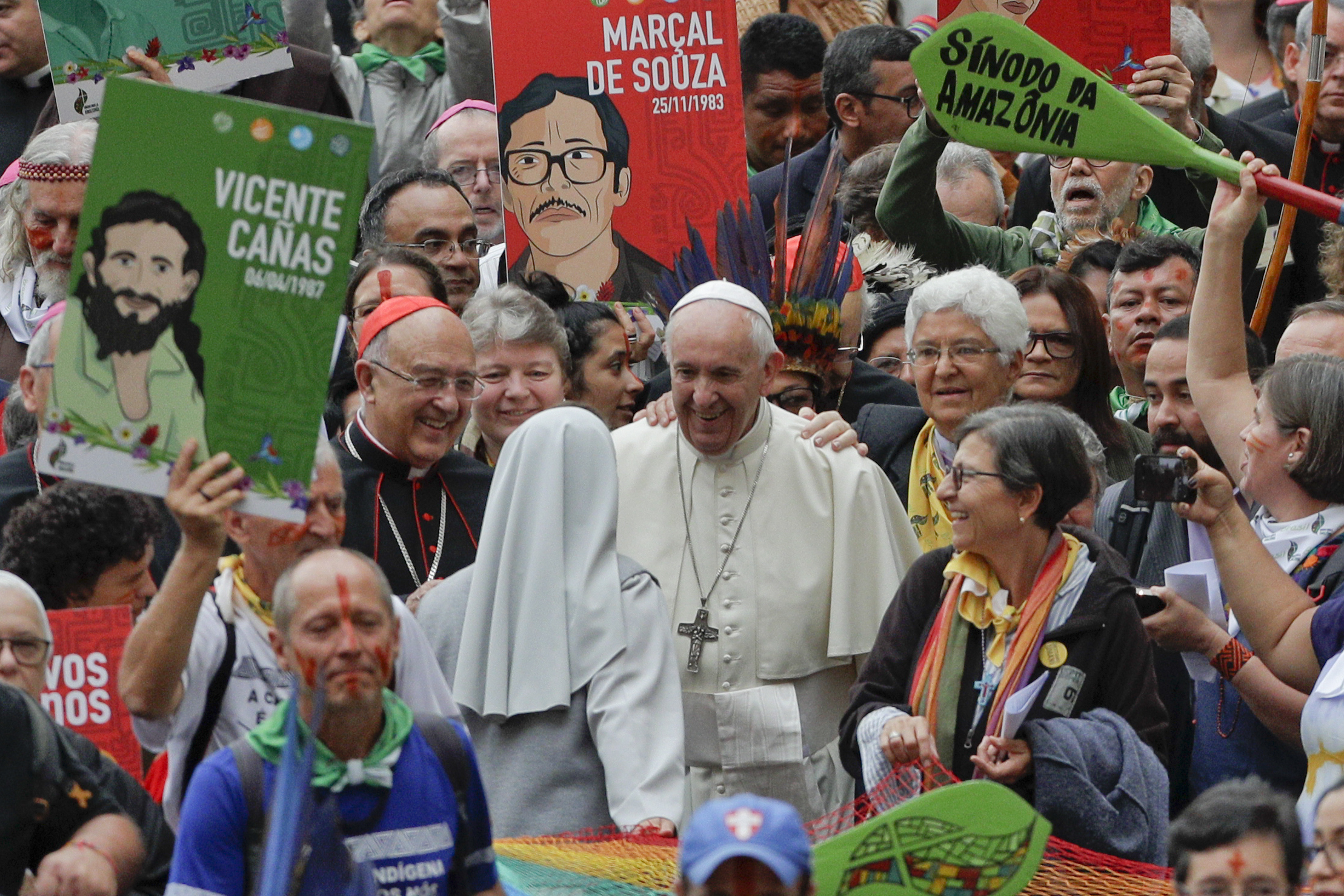 Pope Francis smiles to a nun as he walks in procession on the occasion of the Amazon synod, at the Vatican, Monday, Oct. 7, 2019. Pope Francis opened a three-week meeting on preserving the rainforest and ministering to its native people as he fended off attacks from conservatives who are opposed to his ecological agenda. (AP Photo/Andrew Medichini)