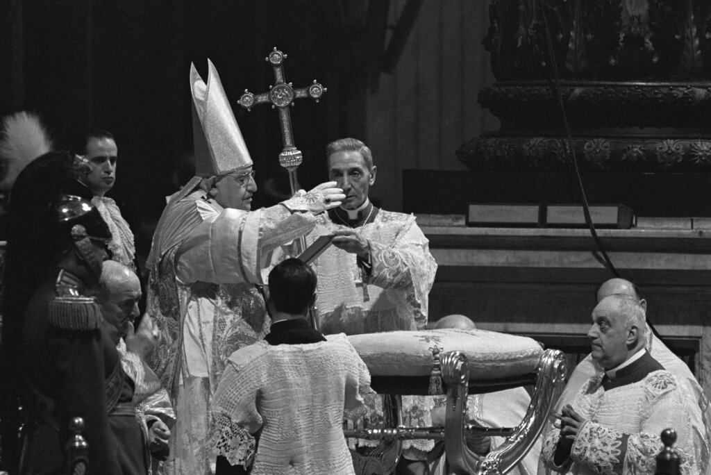 FILE - Pope John XXIII waves a hand in blessing at Roman Catholic Ecumenical Council at St. Peter's Basilica in Vatican City, Oct. 11, 1962. Pope Francis commemorates the 60th anniversary of the opening of the Second Vatican Council by celebrating a Mass in honor of St. John XXIII, the “good pope” who convened the landmark meetings that modernized the Catholic Church. (AP Photo/Raoul Fornezza, File)