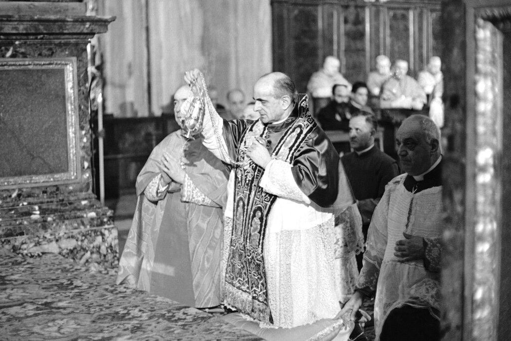 Pope Paul VI incenses the altar of the Basilica of Saint Mary Major in Rome during a solemn religious ceremony on the first anniversary of the opening of the Roman Catholic Ecumenical Council, Oct. 11, 1963. About 2,000 of the 2,500 Council Fathers gathered for the second session of the Council, attended the ceremony.  (AP Photo/Girolamo Di Majo)
