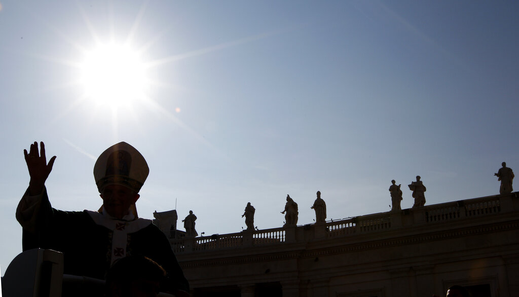 Pope Benedict XVI is silhouetted as he arrives to celebrate a mass marking the 50th anniversary of the Second Vatican Council, in St. Peter's square at the Vatican, Thursday, Oct. 11, 2012. Benedict, after celebrating mass, will greet churchmen, including a dozen original Vatican II participants, re-enacting the great procession into St. Peter's that launched the council in 1962. (AP Photo/Andrew Medichini)