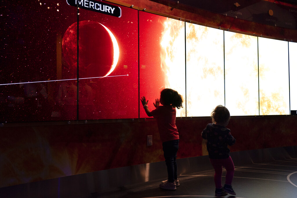 Children play at an exhibit inside the 