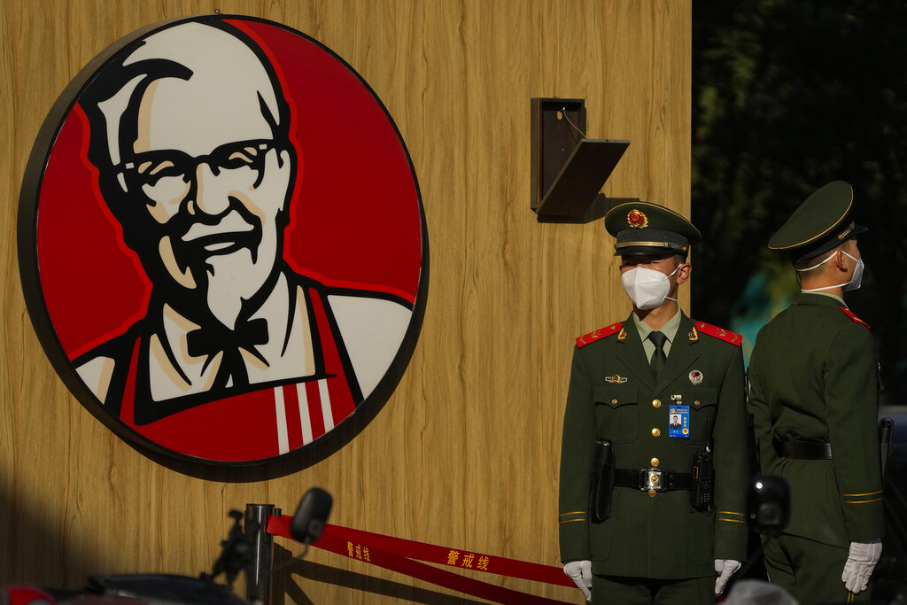 Paramilitary police wearing face masks stand guard outside a KFC fast food restaurant during the opening ceremony of the 20th National Congress of China's ruling Communist Party in Beijing, Sunday, Oct. 16, 2022. Chinese leader Xi Jinping signaled Sunday that his government would maintain policies that have put it at odds with the U.S. and other nations and deepened Communist Party control of the economy and society. (AP Photo/Andy Wong)