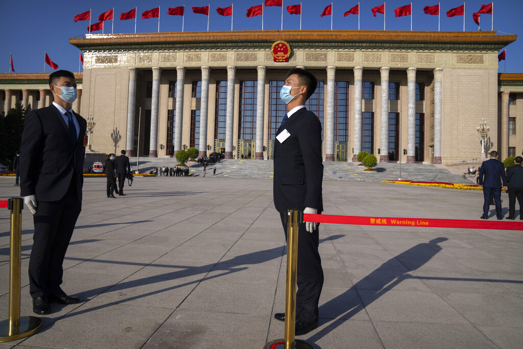 Security personnel stand outside the Great Hall of the People before the opening ceremony of the 20th National Congress of China's ruling Communist Party in Beijing, Sunday, Oct. 16, 2022. The overarching theme emerging from China's ongoing Communist Party congress is one of continuity, not change. The weeklong meeting is expected to reappoint Xi Jinping as leader, reaffirm a commitment to his policies for the next five years and possibly elevate his status even further as one of the most powerful leaders in China's modern history. (AP Photo/Mark Schiefelbein)