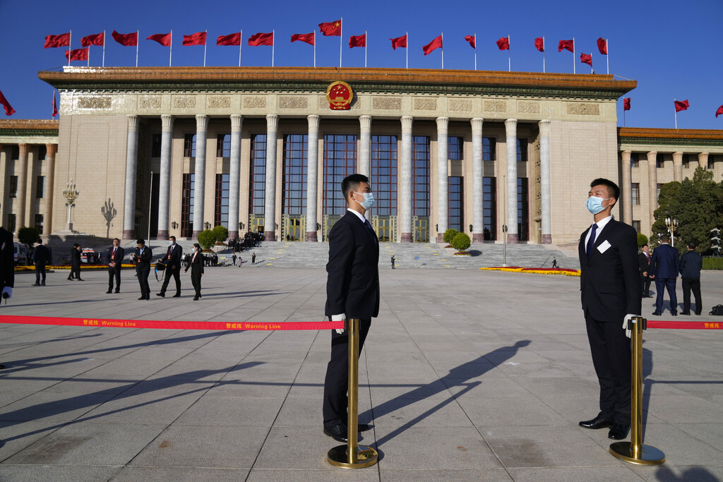 Security personnel stand guard in front of the Great Hall of the People before the opening ceremony for the 20th National Congress of China's ruling Communist Party in Beijing, China, Sunday, Oct. 16, 2022. China on Sunday opens a twice-a-decade party conference at which leader Xi Jinping is expected to receive a third five-year term that breaks with recent precedent and establishes himself as arguably the most powerful Chinese politician since Mao Zedong. (AP Photo/Mark Schiefelbein)