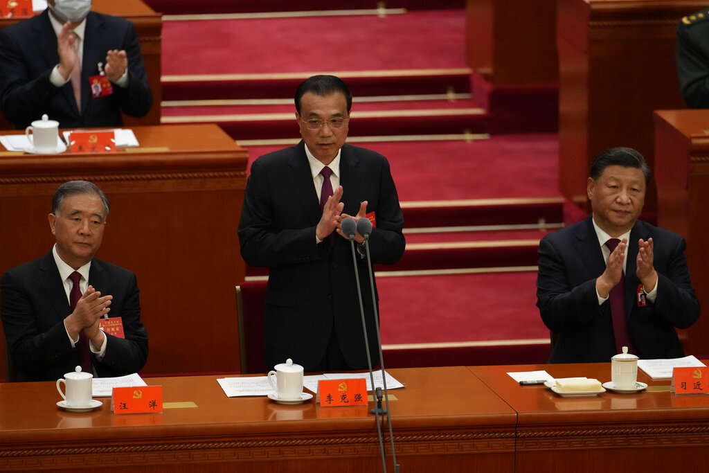 Chinese Premier Li Keqiang speaks near Chinese President Xi Jinping during the opening ceremony of the 20th National Congress of China's ruling Communist Party held at the Great Hall of the People in Beijing, China, Sunday, Oct. 16, 2022. China on Sunday opens a twice-a-decade party conference at which leader Xi Jinping is expected to receive a third five-year term that breaks with recent precedent and establishes himself as arguably the most powerful Chinese politician since Mao Zedong. (AP Photo/Mark Schiefelbein)