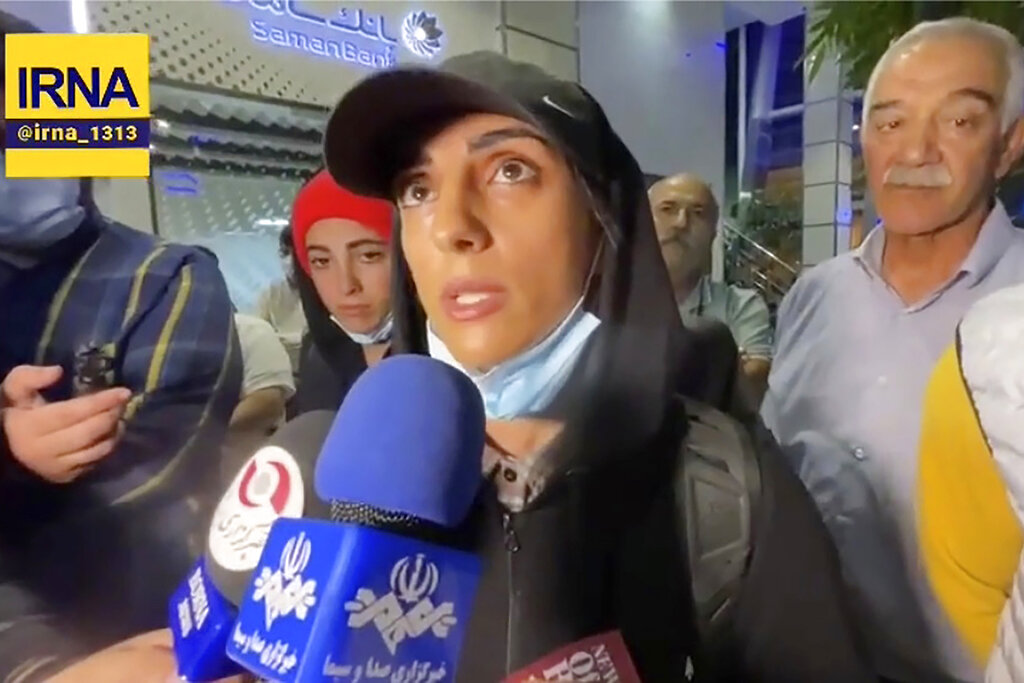 In this image taken from video by Iran's state-run IRNA news agency, Iranian competitive climber Elnaz Rekabi speaks to journalists in Imam Khomeini International Airport in Tehran, Iran, Wednesday, Oct. 19, 2022. Rekabi received a hero's welcome on her return to Tehran early Wednesday, after competing in South Korea without wearing a mandatory headscarf required of female athletes from the Islamic Republic. Rekabi has described her not wearing a hijab as 