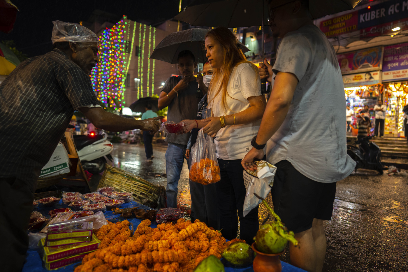 People buy marigold flower and other things to worship for Diwali festival in Guwahati, northeastern Assam state, India, Monday, Oct. 24, 2022. (AP Photo/Anupam Nath)