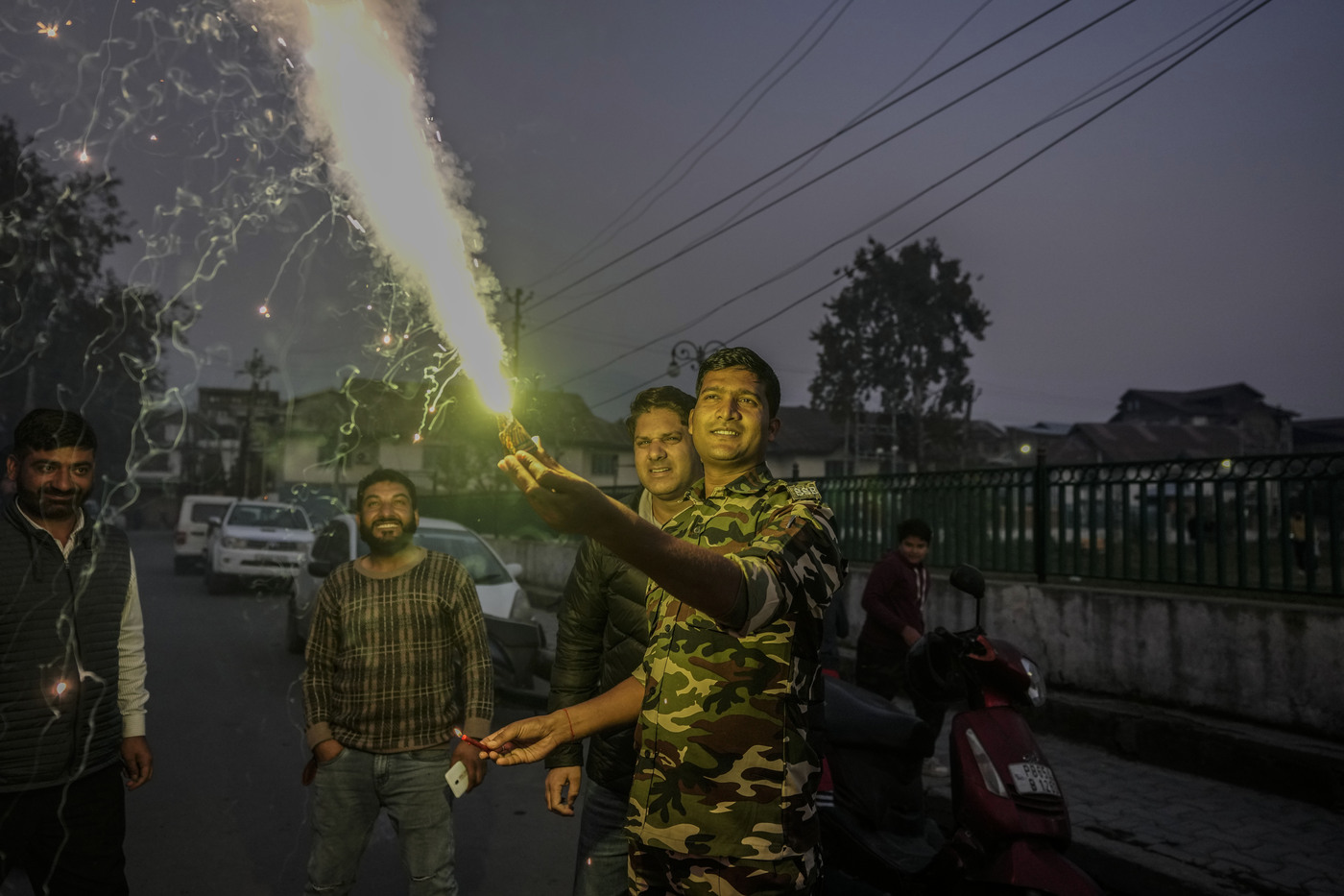 An Indian paramilitary soldier burns firecrackers to celebrate Diwali, the Hindu festival of lights in Srinagar, Indian controlled Kashmir, Monday, Oct. 24, 2022. (AP Photo/Mukhtar Khan)
