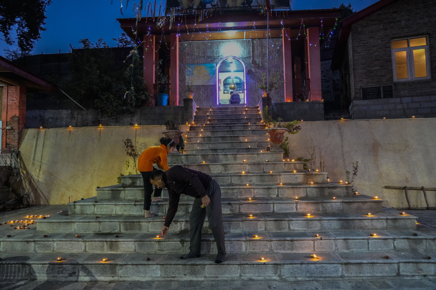Hindus light candle outside the stairs of a temple as they celebrate Diwali, the Hindu festival of lights in Srinagar, Indian controlled Kashmir, Monday, Oct. 24, 2022.(AP Photo/Mukhtar Khan)