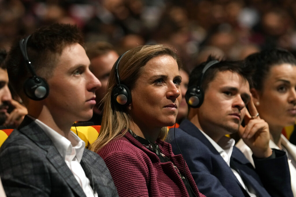 Netherland's Annemiek Van Vleuten, center, and Slovenian Tadej Pogacar, left, attend the presentation of the Tour de France 2023 cycling race, in Paris, Thursday Oct. 27, 2022. The 110th edition of the race starts on July 1 2023 to end on the Champs-Elysees avenue on July 23 2022. (AP Photo/Thibault Camus)