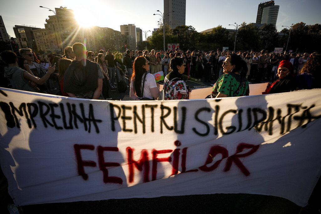 People take part in a protest aiming to raise awareness to the violence and prejudice against women in Romanian society in Bucharest, Romania, Sunday, Oct. 23, 2022. Participants called for better support and protection for the victims of violence and the implementation of a national strategy to ensure gender equality and combat domestic violence. Banner reads: 