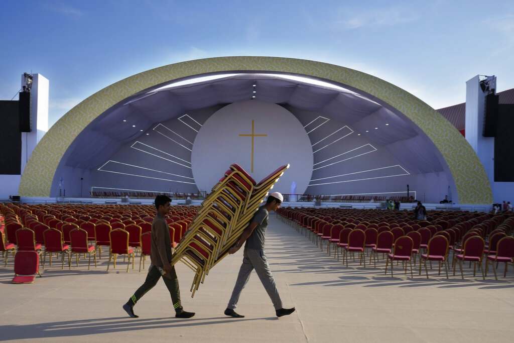 Workers carry chairs to be set at a stadium where the Pope Francis will attend a Mass, in Manama, Bahrain, Wednesday, Nov. 2, 2022. Pope Francis is making the November 3-6 visit to participate in a government-sponsored conference on East-West dialogue and to minister to Bahrain's tiny Catholic community, part of his effort to pursue dialogue with the Muslim world. (AP Photo/Hussein Malla)